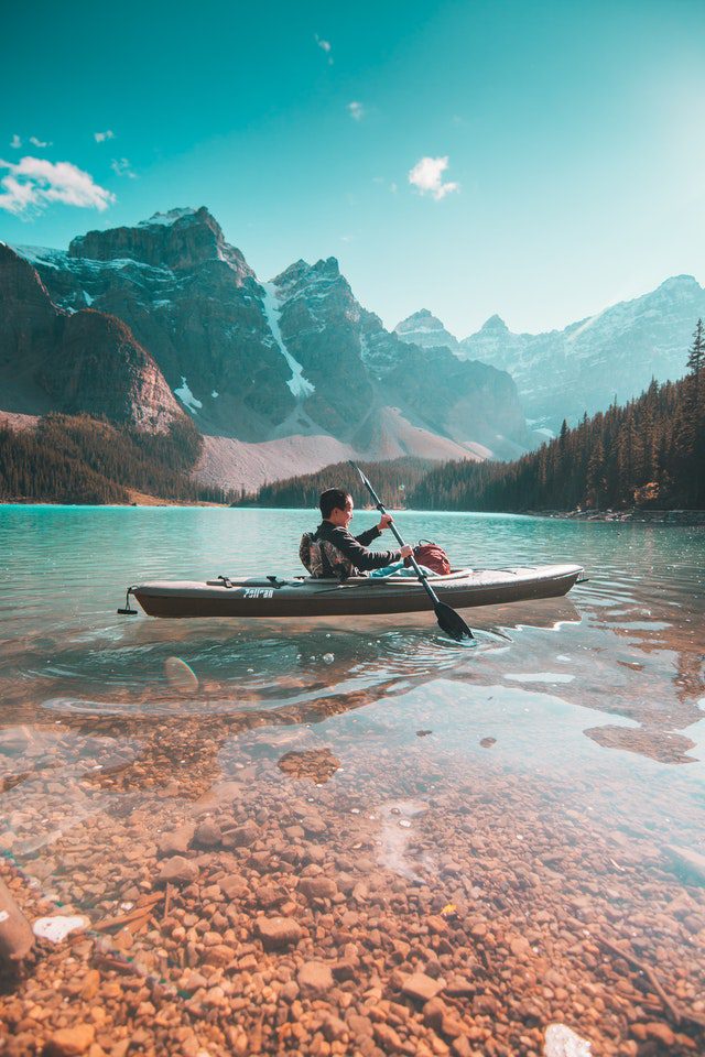 A man kayaking on a Canadian lake and enjoying the great outdoors!